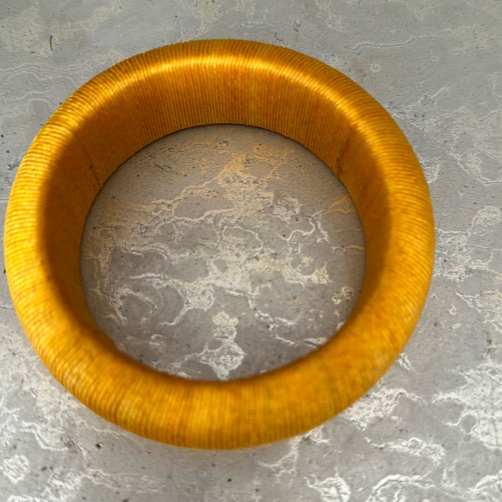 Yellow bangle wrapped tightly thread